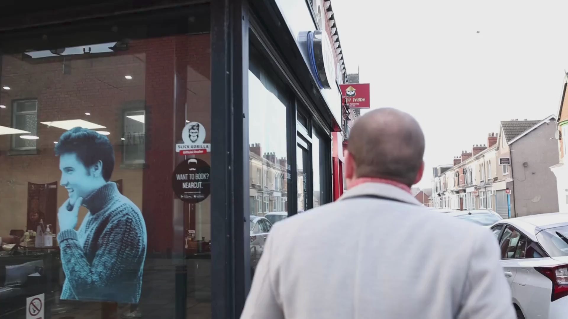 Load video: A customer arrives at the professional barber shop and gets a haircut and beard trim.